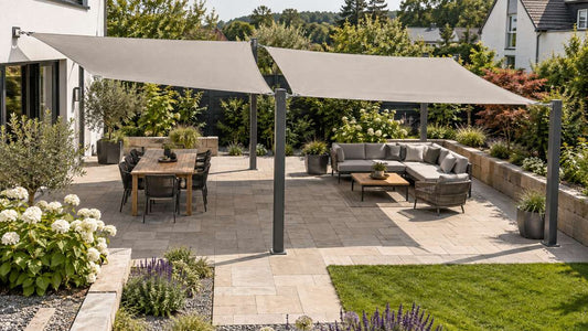Zwei getrennte Sonnensegel überspannen eine große Terrasse mit nachvollziehbaren Wand- und Pfostenanschlüssen